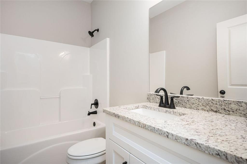 301 C W Sims Road Hiram, GA 30141 - Photo 24 of 29 a bathroom with a granite countertop sink toilet and shower