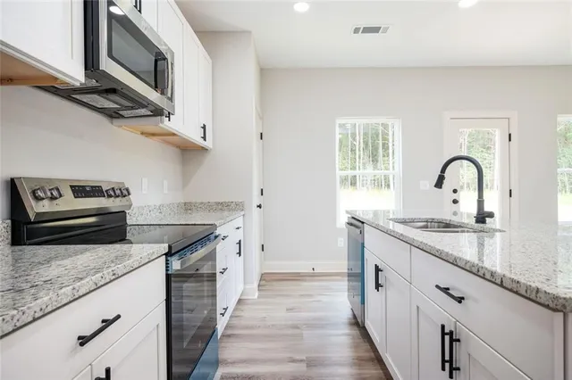 a view of empty room with wooden floor and window
