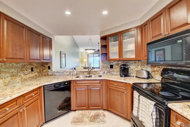 a dining room with furniture a chandelier and a rug