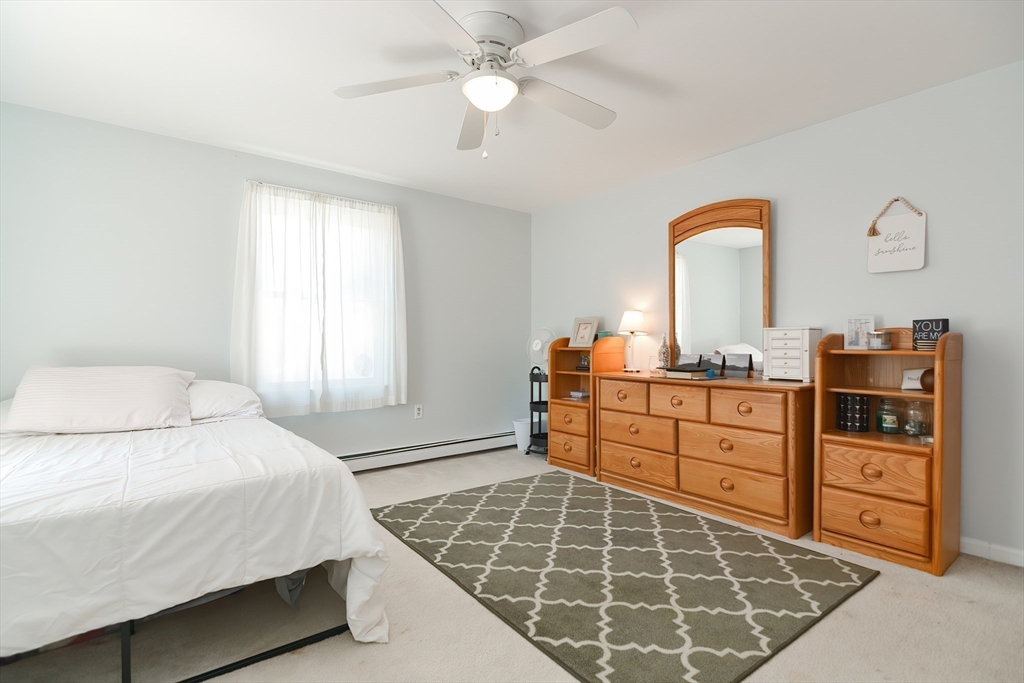 9 Davidson Road Framingham, MA 01701 - Photo 26 of 31 a bedroom with a bed and a chandelier