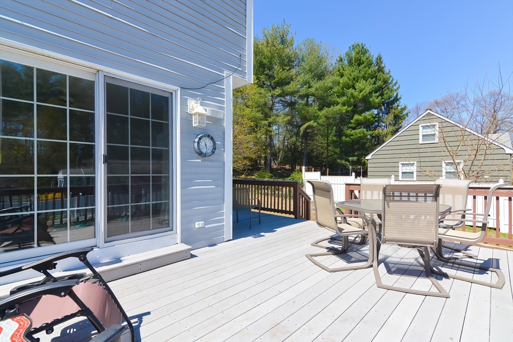 9 Davidson Road Framingham, MA 01701 - Photo 4 of 31 a view of a deck with table and chairs with wooden floor and fence