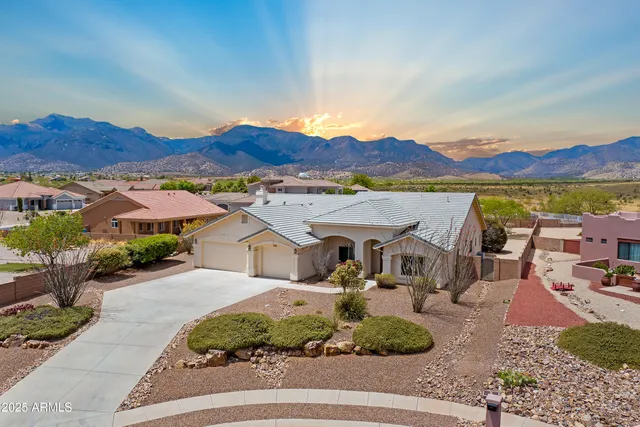 a view of a house with outdoor space and a car park in the back