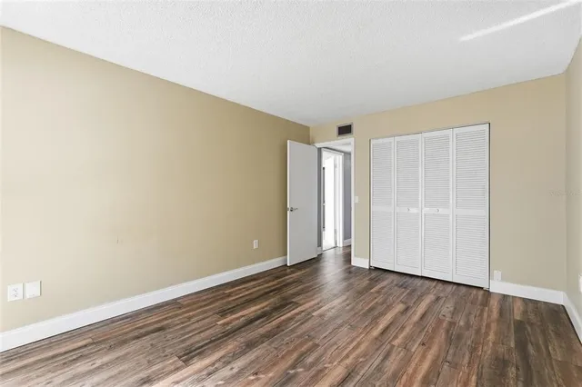 a view of an empty room and wooden floor