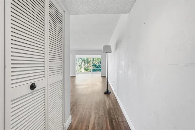 a view of a hallway with wooden floor