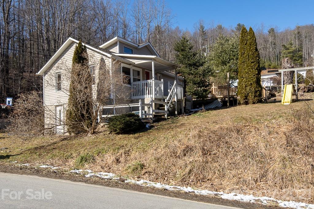 1321 Orchard Road Deep Gap, NC 28618 - Photo 2 of 40 a front view of a house with a yard covered in snow