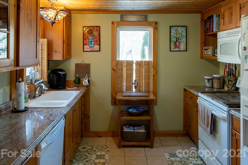 1321 Orchard Road Deep Gap, NC 28618 - Photo 13 of 40 a kitchen with a sink stove and cabinets