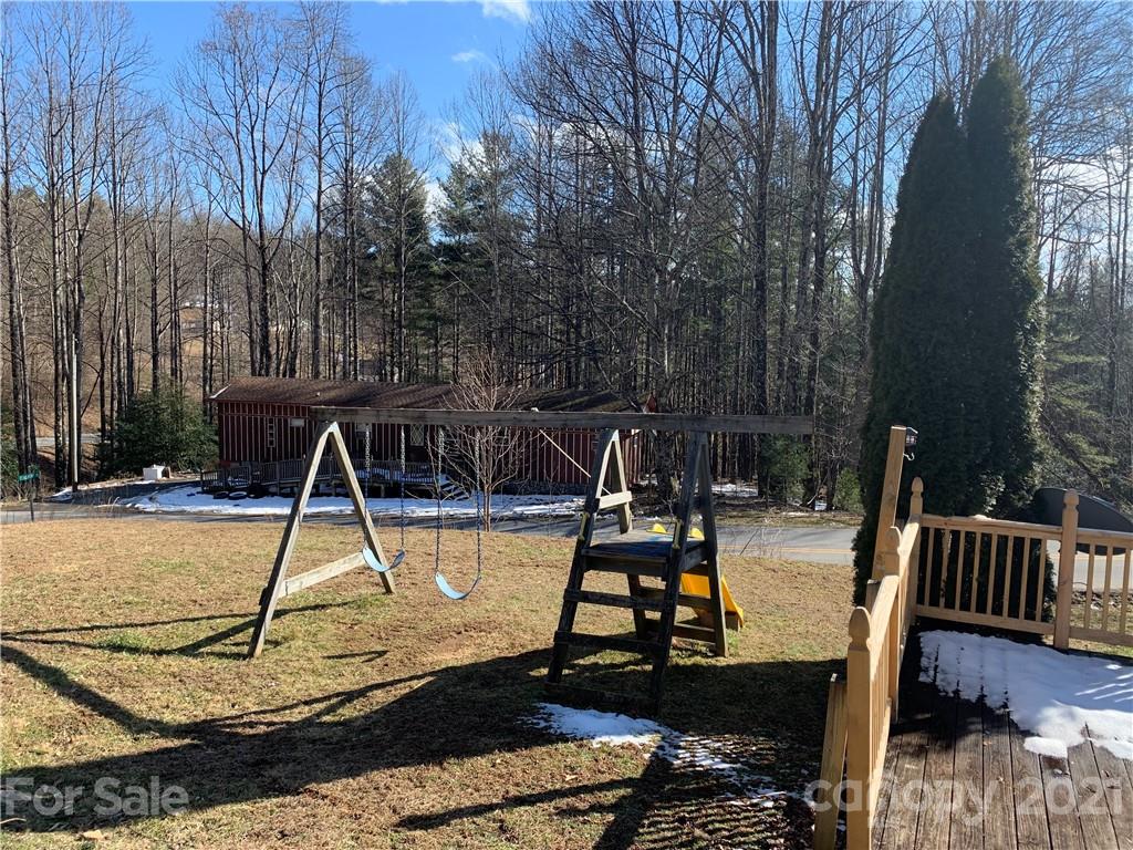 1321 Orchard Road Deep Gap, NC 28618 - Photo 15 of 40 a view of a swimming pool with a patio and a yard
