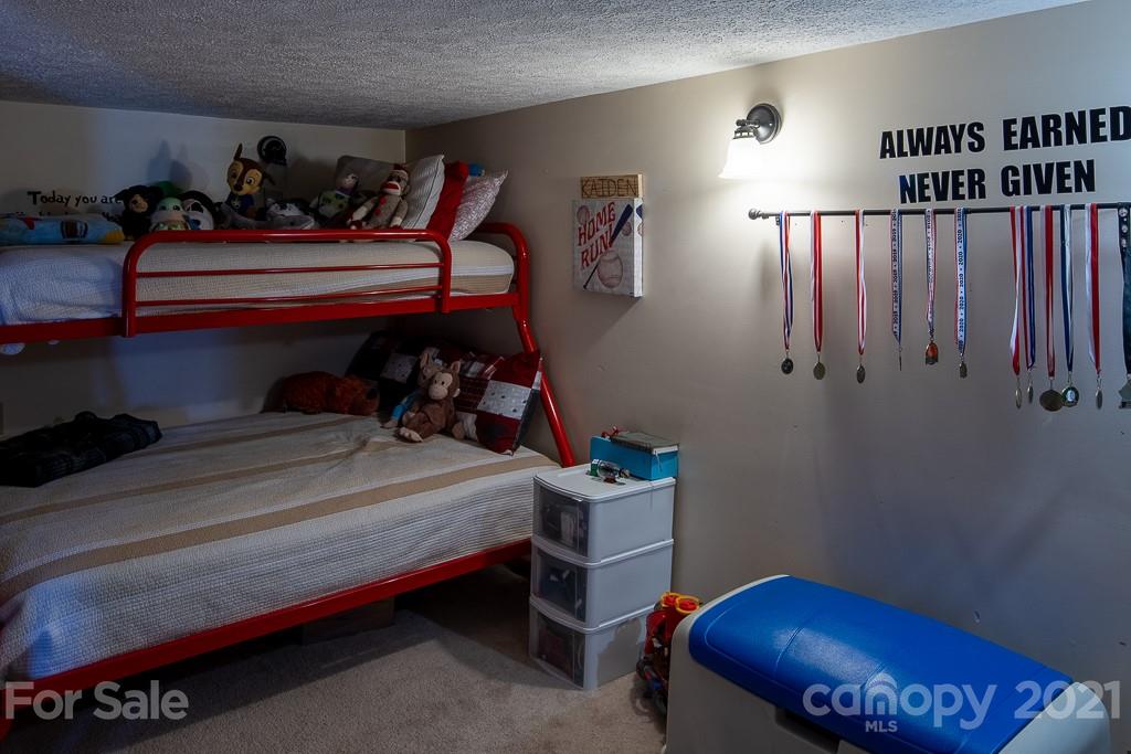 1321 Orchard Road Deep Gap, NC 28618 - Photo 31 of 40 a bed room with furniture and a window