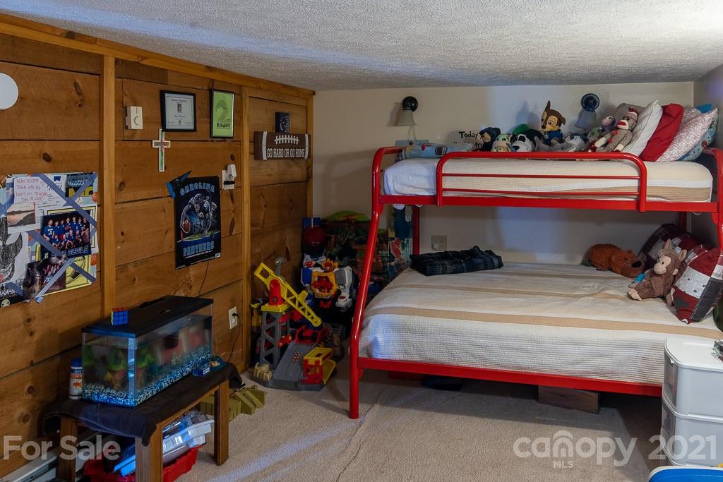 1321 Orchard Road Deep Gap, NC 28618 - Photo 32 of 40 a bed room with a bed and a tv