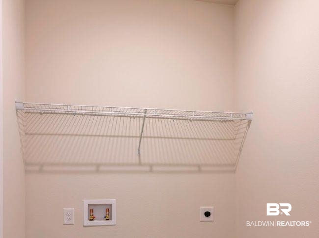 13791 Logan Place Foley, AL 36535 - Photo 23 of 25 Laundry area featuring a white wire shelf, water hookups, and an electrical outlet