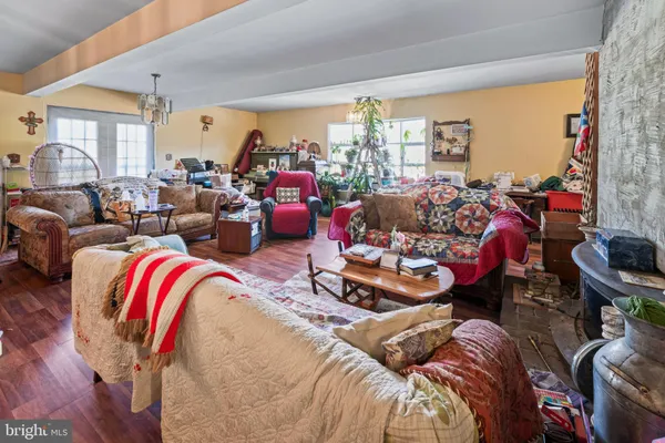 a living room with furniture and a chandelier