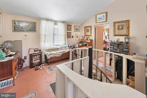 a living room with furniture a rug and a window