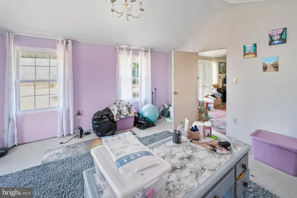 a bedroom with a bed and a tv on the wall