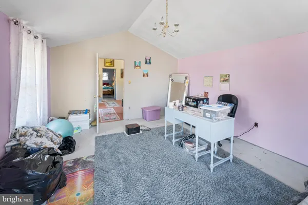 a living room with furniture and a dresser