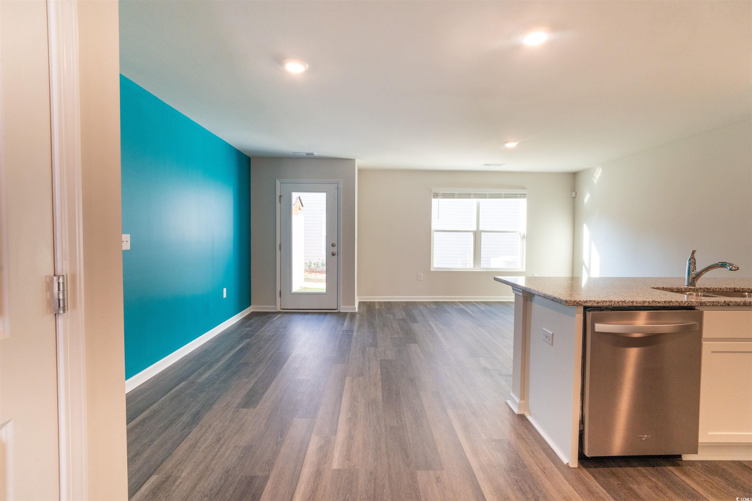 160 Harvest Gold Drive Conway, SC 29526 - Photo 36 of 37 Kitchen with stainless steel dishwasher, dark wood finished floors, light stone counters, white cabinets, and open floor plan