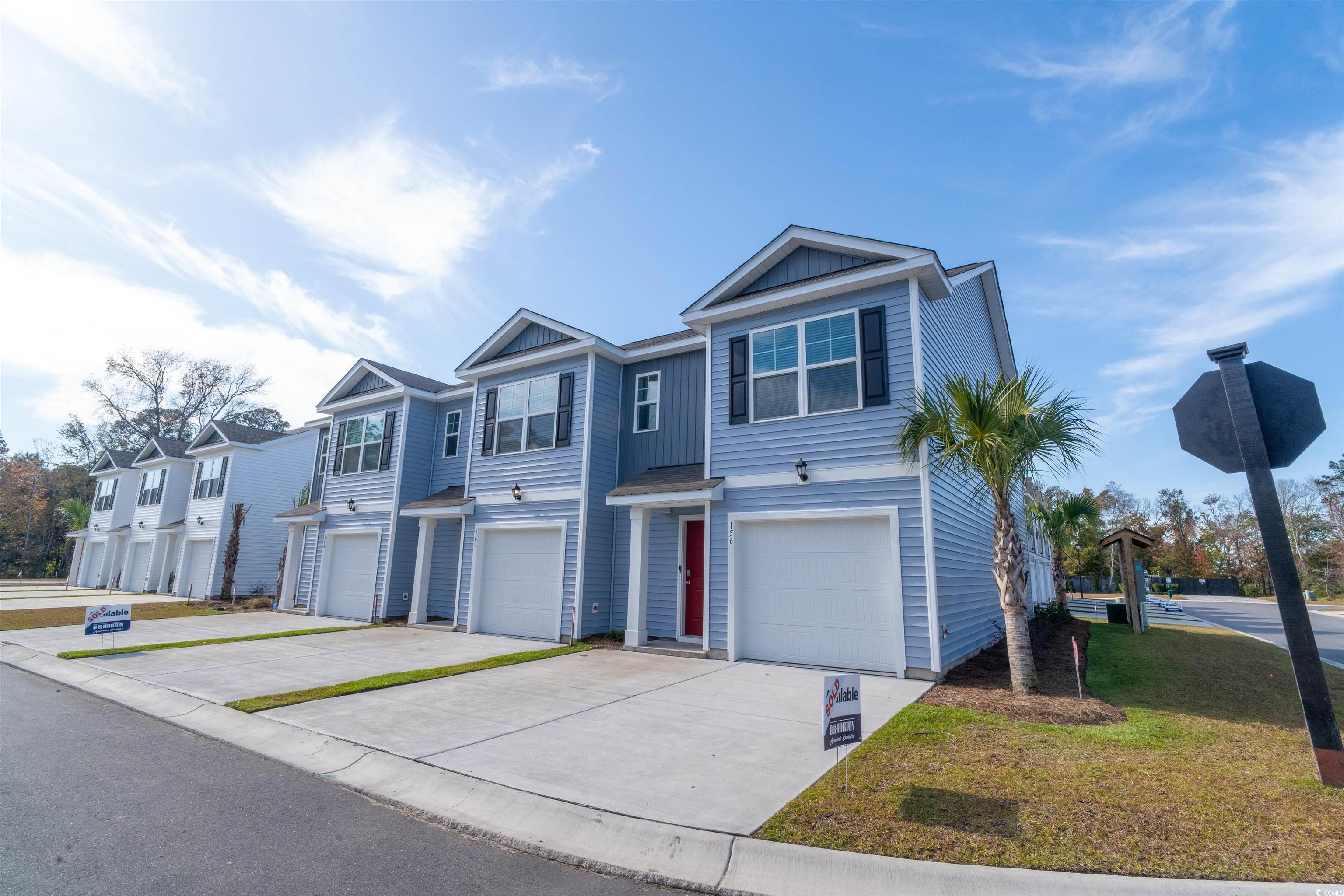 160 Harvest Gold Drive Conway, SC 29526 - Photo 2 of 37 Traditional-style home with driveway, an attached garage, a residential view, and board and batten siding