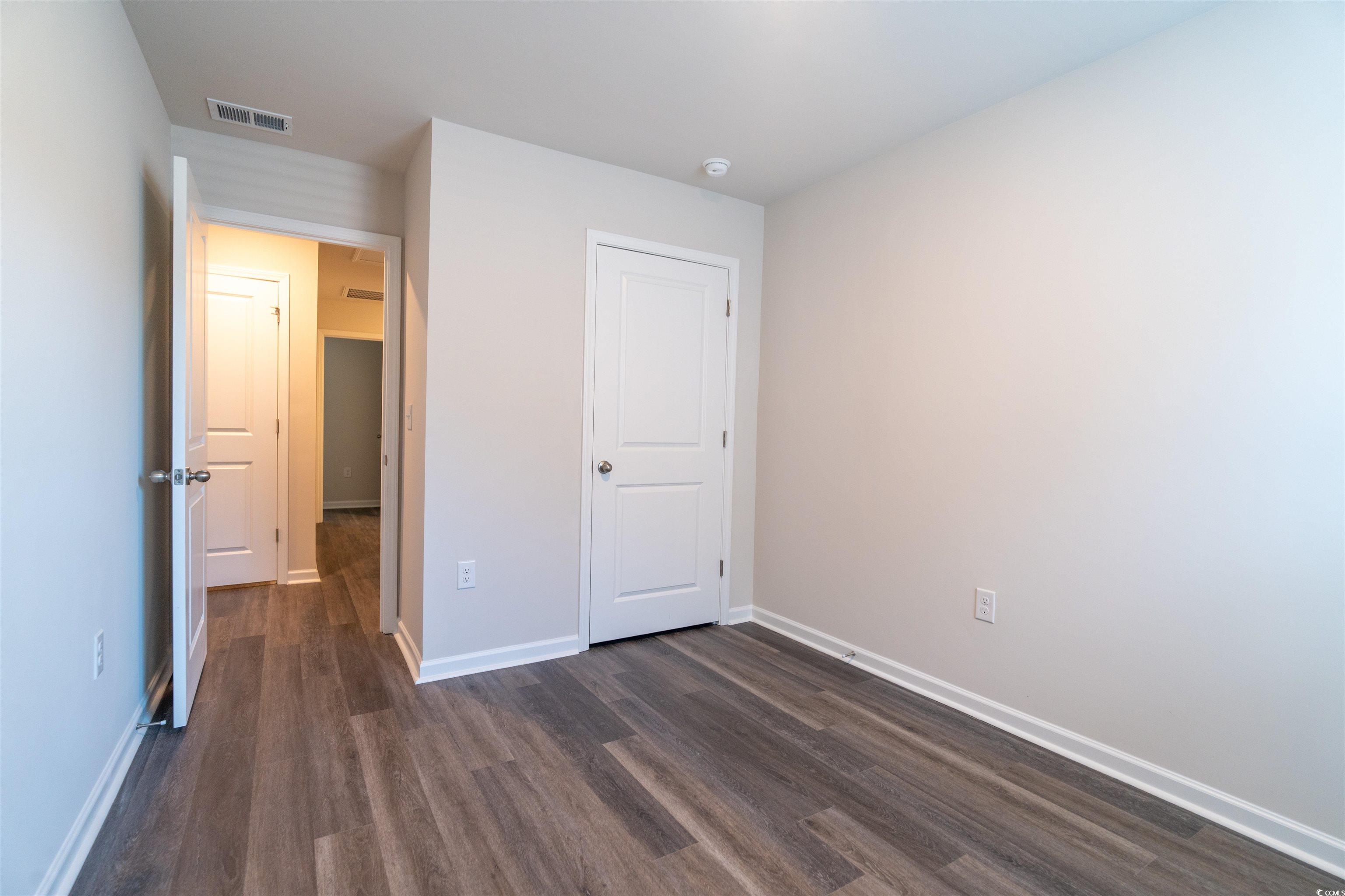 160 Harvest Gold Drive Conway, SC 29526 - Photo 27 of 37 Unfurnished bedroom with dark wood finished floors and baseboards