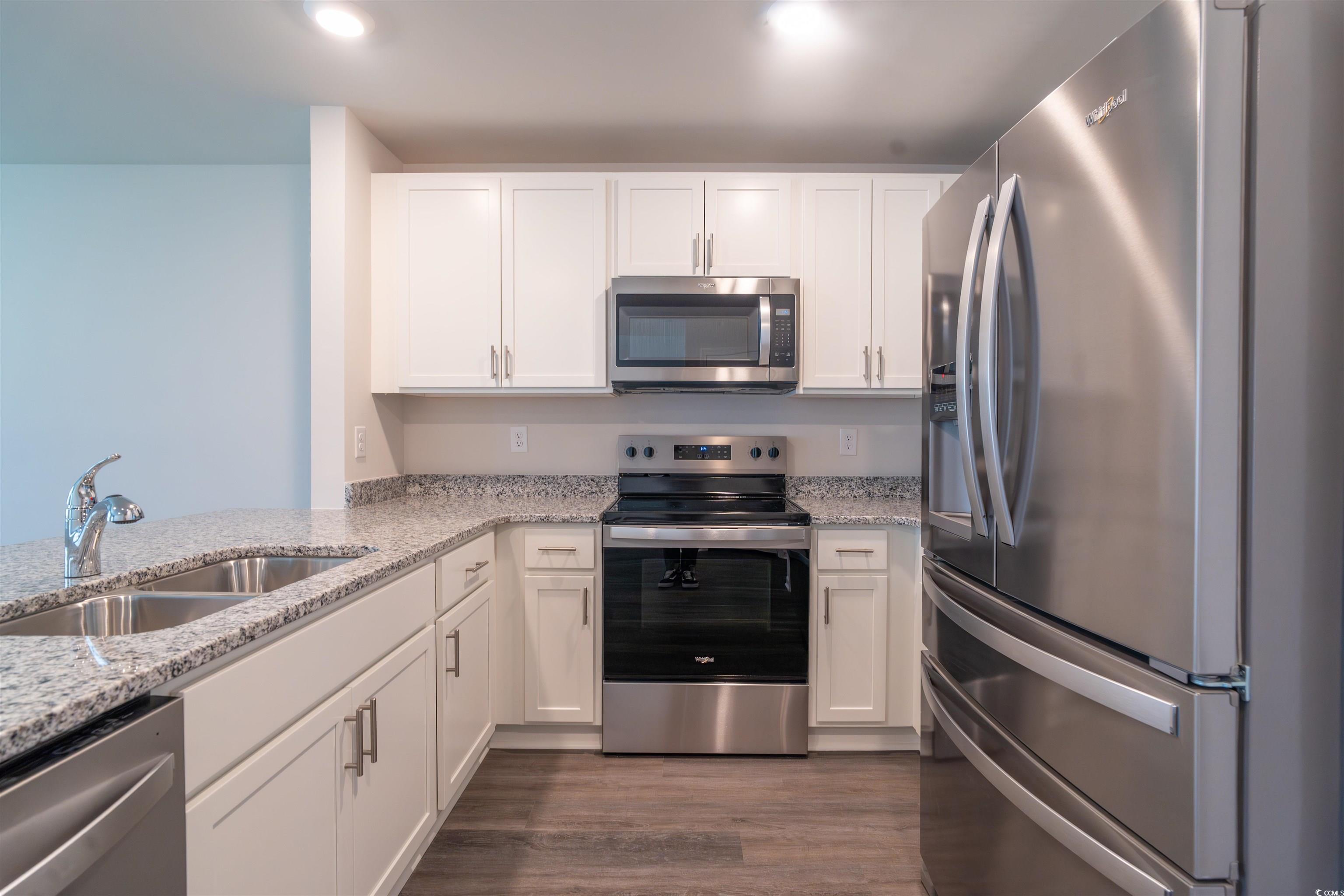160 Harvest Gold Drive Conway, SC 29526 - Photo 10 of 37 Kitchen featuring appliances with stainless steel finishes, white cabinetry, light stone counters, and dark wood-style floors