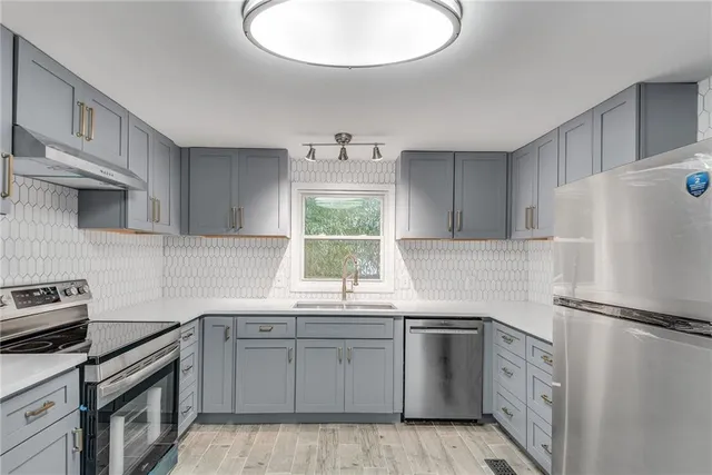 a kitchen with white cabinets and white appliances