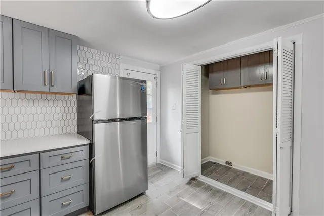 a kitchen with a refrigerator and cabinets