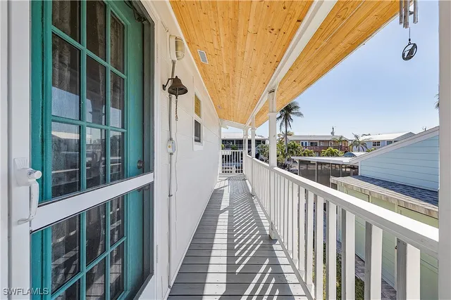a view of a balcony with wooden floor and fence