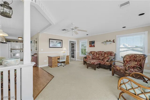 a bedroom with furniture and a large window
