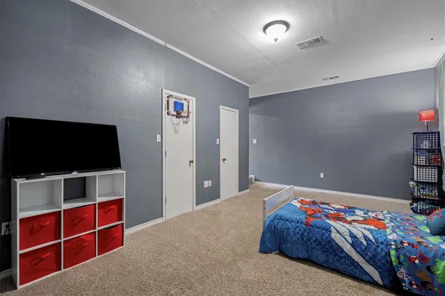 a bedroom with furniture and a flat screen tv