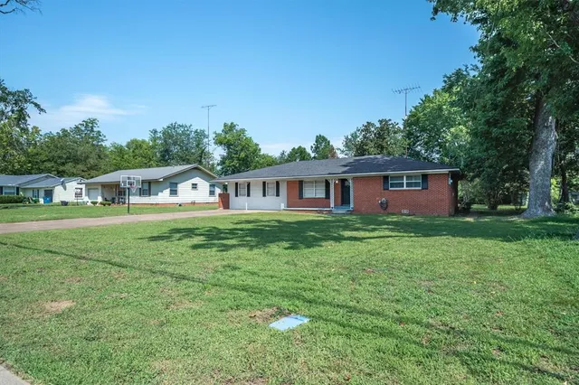 a front view of house with yard and green space