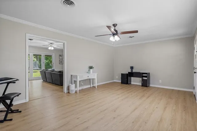 a view of a livingroom with furniture and a ceiling fan