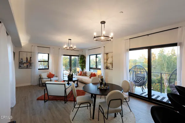 a kitchen with refrigerator and chairs
