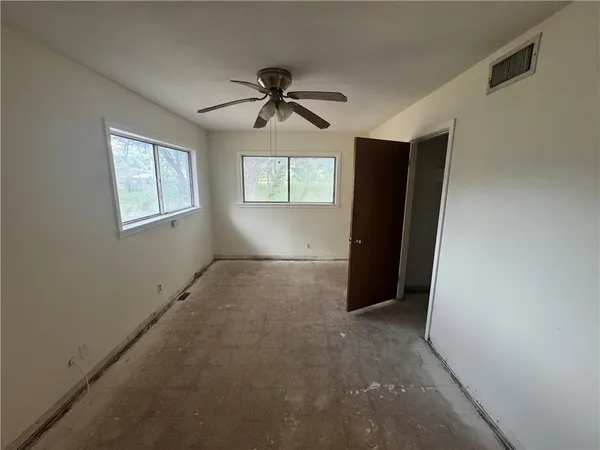 a view of empty room with windows