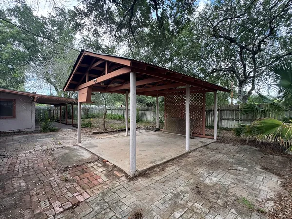 a backyard of a house with table and chairs