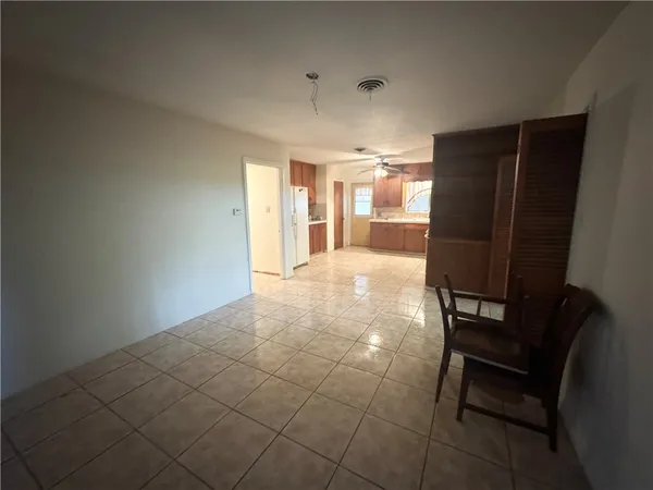 a view of a hallway with wooden floor and a cabinet