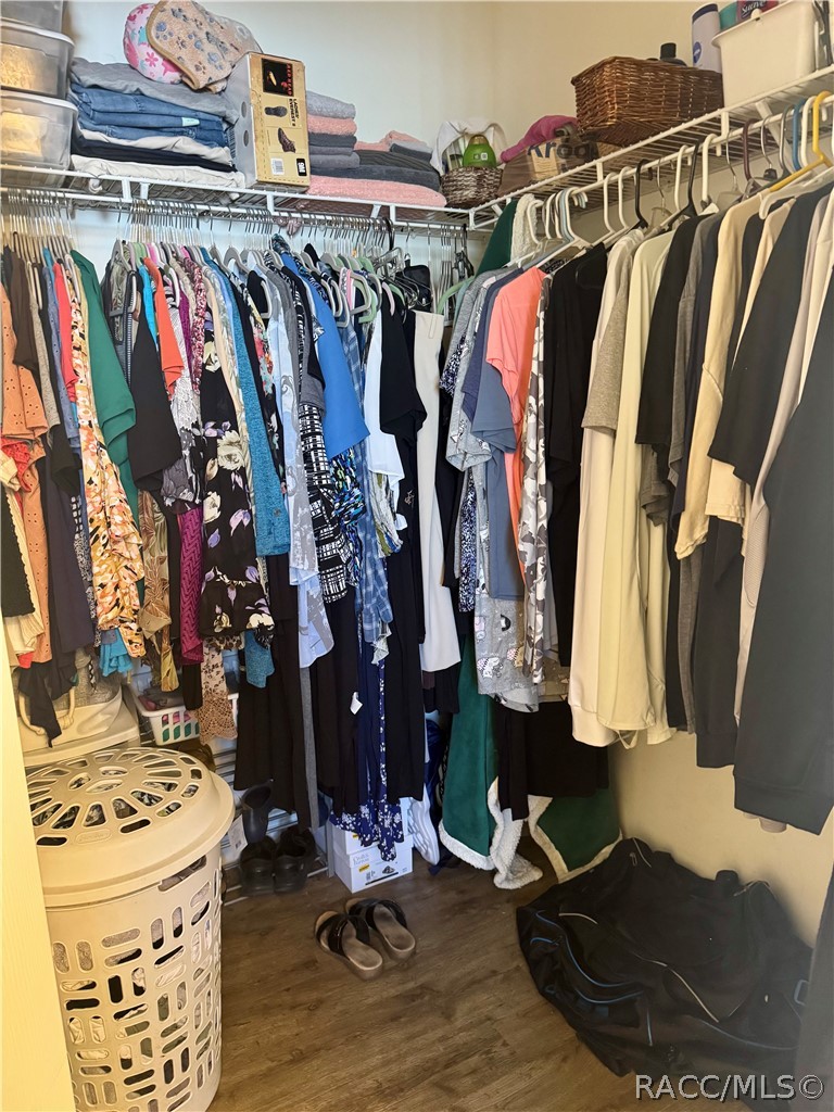 4588 East Van Ness Road Inverness, FL 34453 - Photo 23 of 34 a view of walk in closet with clothes and shoes