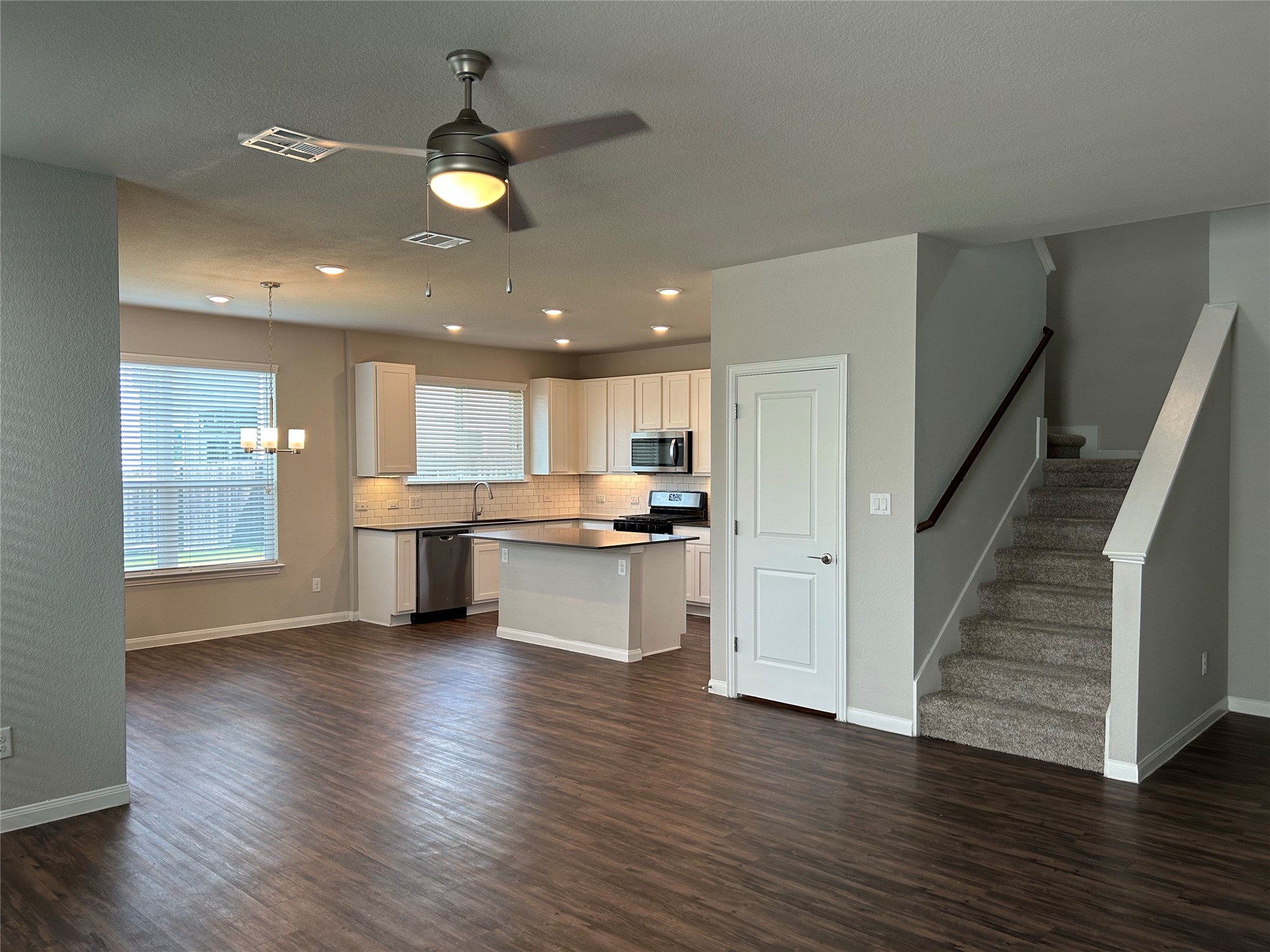 424 San Gabriel River Road Georgetown, TX 78626 - Photo 6 of 8 An open-concept living space with a contemporary kitchen and durable wood-look flooring provides versatile appeal.