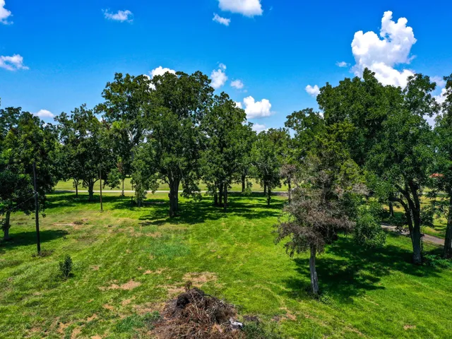 a backyard of a house with lots of green space and lake view
