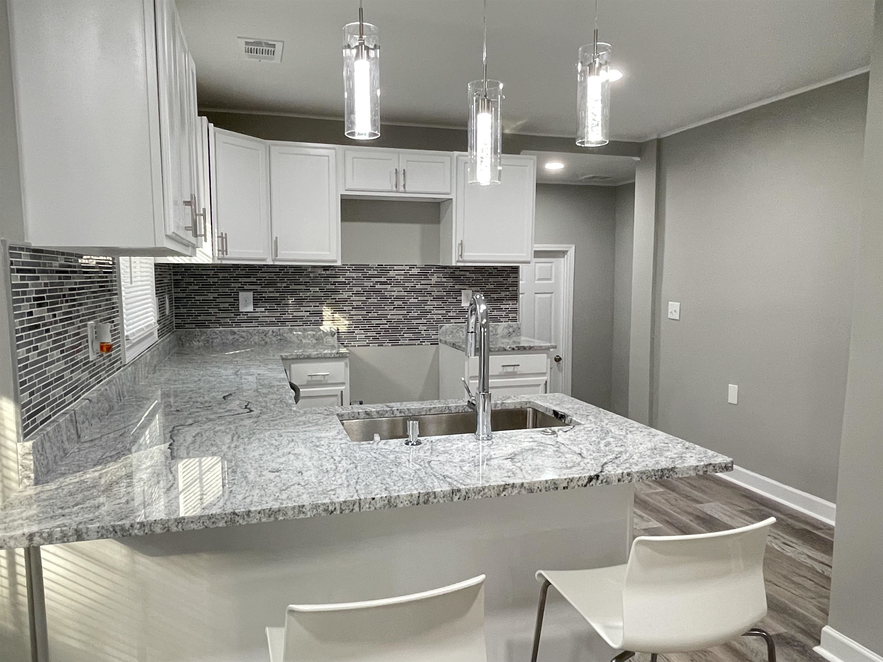 4409 Boyce Road Memphis, TN 38117 - Photo 7 of 25 a kitchen with kitchen island granite countertop a sink and a stove