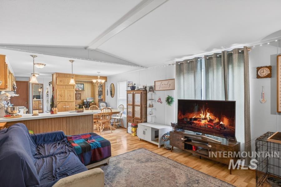 609 North Almon Street, Unit 3024 Moscow, ID 83843 - Photo 3 of 17 Living room featuring light wood-type flooring and a chandelier