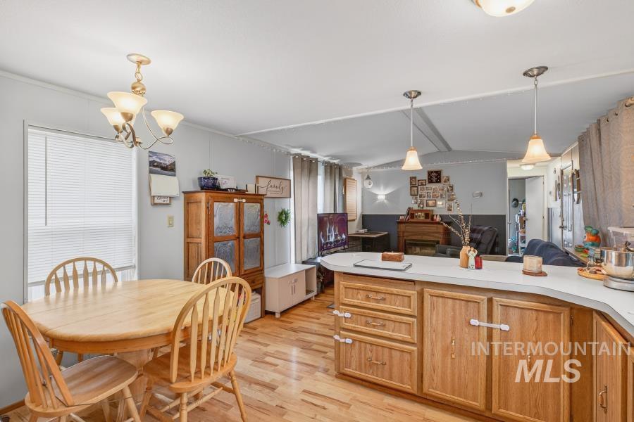 609 North Almon Street, Unit 3024 Moscow, ID 83843 - Photo 17 of 17 Kitchen featuring open floor plan, light countertops, pendant lighting, a peninsula, and light wood-style floors