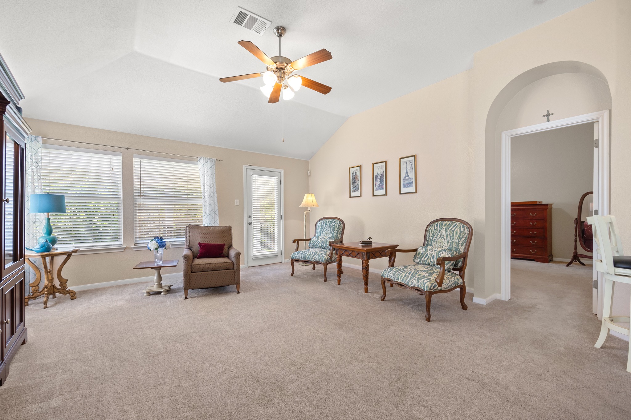 1108 Springbrook Road Pflugerville, TX 78660 - Photo 14 of 37 A vaulted ceiling living room with plush carpet, bathed in natural light, offers an inviting ambiance.