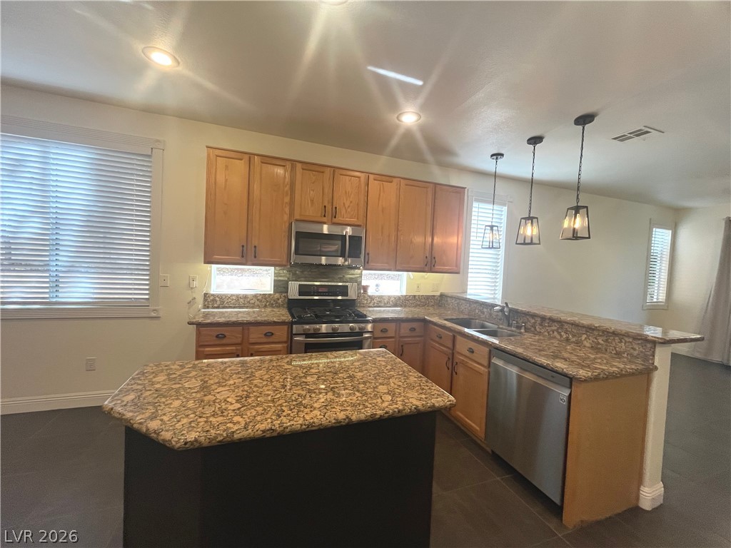 1809 Snow Spring Lane Las Vegas, NV 89134 - Photo 12 of 75 Kitchen w/island & breakfast bar w/granite counters, SS appl, recessed & pendant lights, ceramic tile floors, oak cabinets, dining nook w/add'l cabinets & pantry
