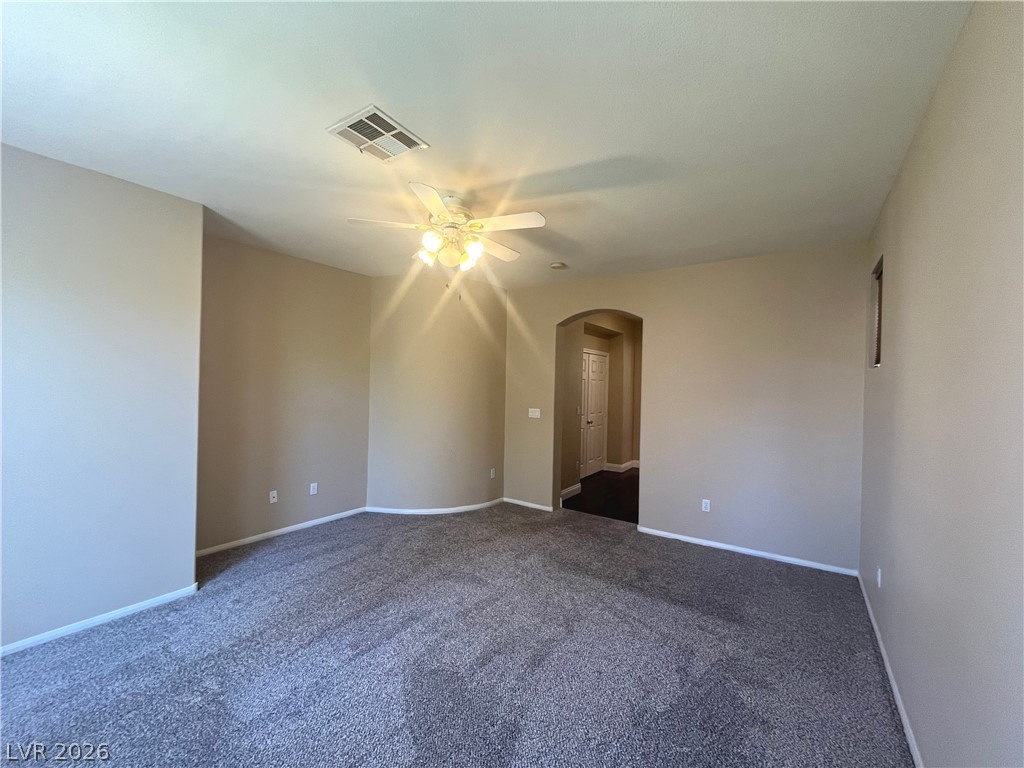 1809 Snow Spring Lane Las Vegas, NV 89134 - Photo 26 of 75 Primary bedroom w/ceiling fan & light, new carpet, two tone paint and walk in closet