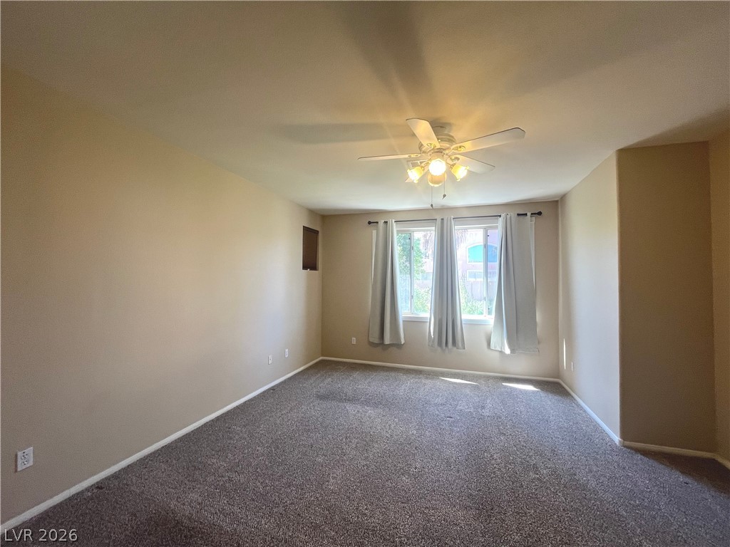 1809 Snow Spring Lane Las Vegas, NV 89134 - Photo 27 of 75 Primary bedroom w/ceiling fan & light, new carpet, two tone paint and walk in closet