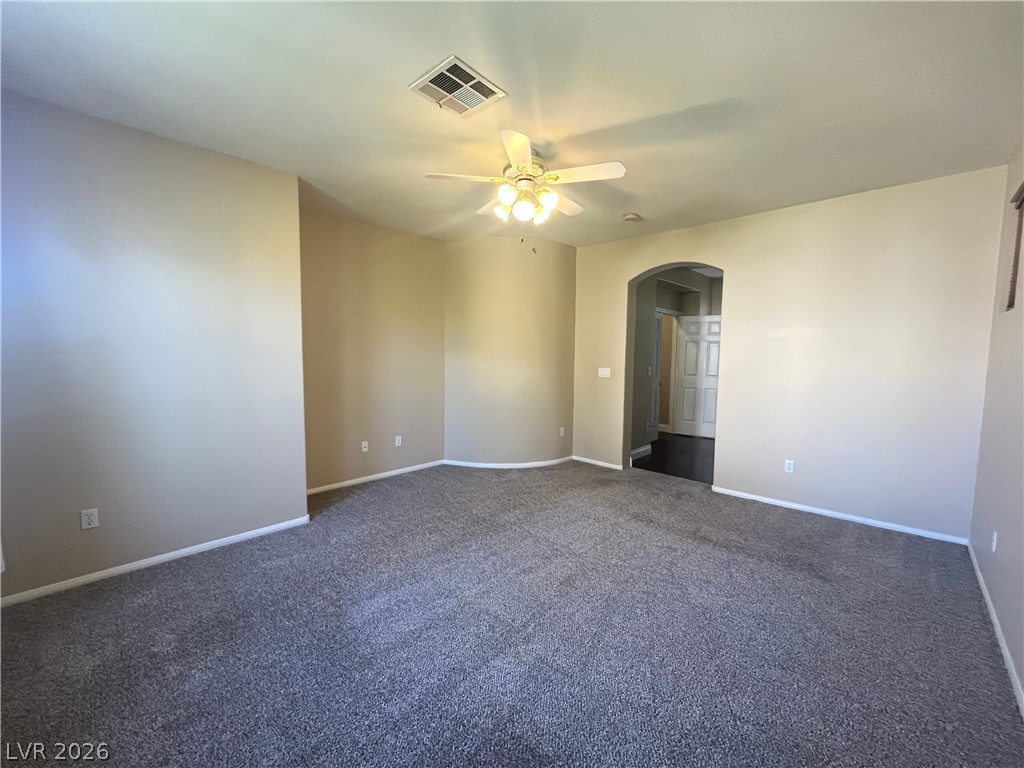 1809 Snow Spring Lane Las Vegas, NV 89134 - Photo 28 of 79 Primary bedroom w/ceiling fan & light, new carpet, two tone paint and walk in closet