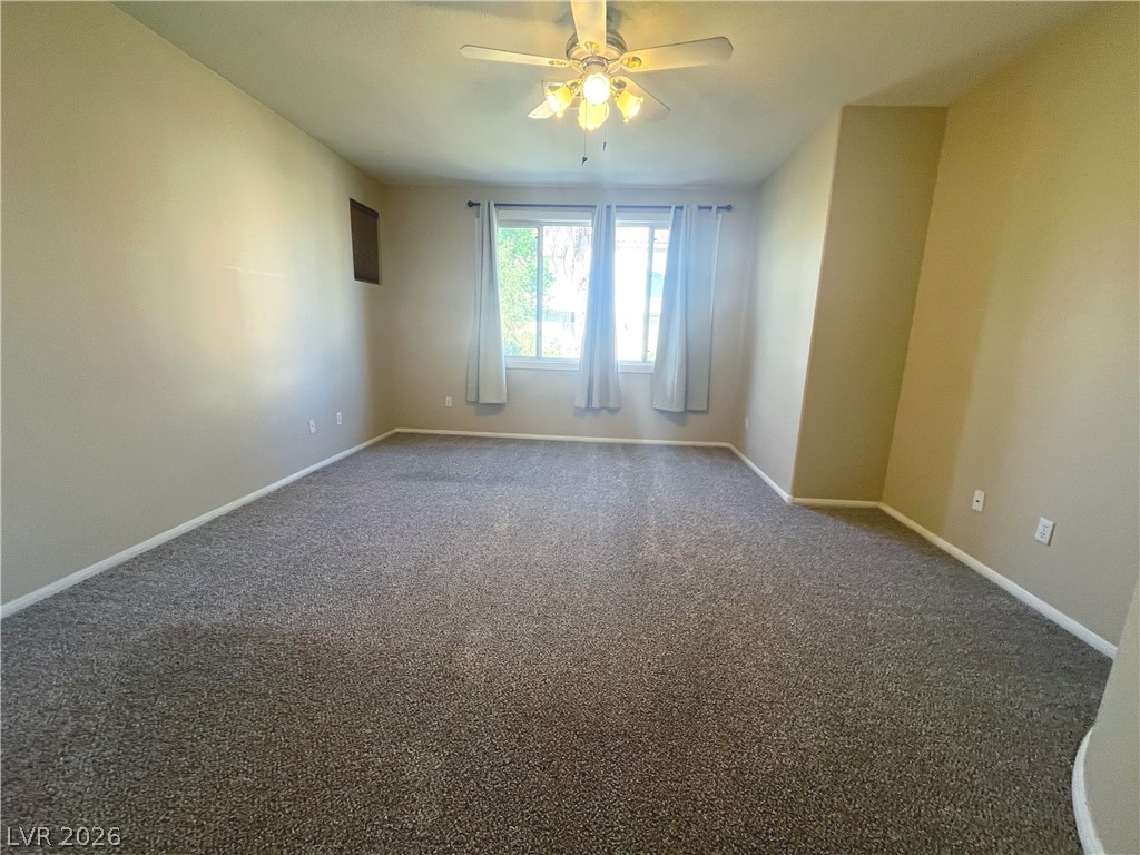 1809 Snow Spring Lane Las Vegas, NV 89134 - Photo 29 of 79 Primary bedroom w/ceiling fan & light, new carpet, two tone paint and walk in closet