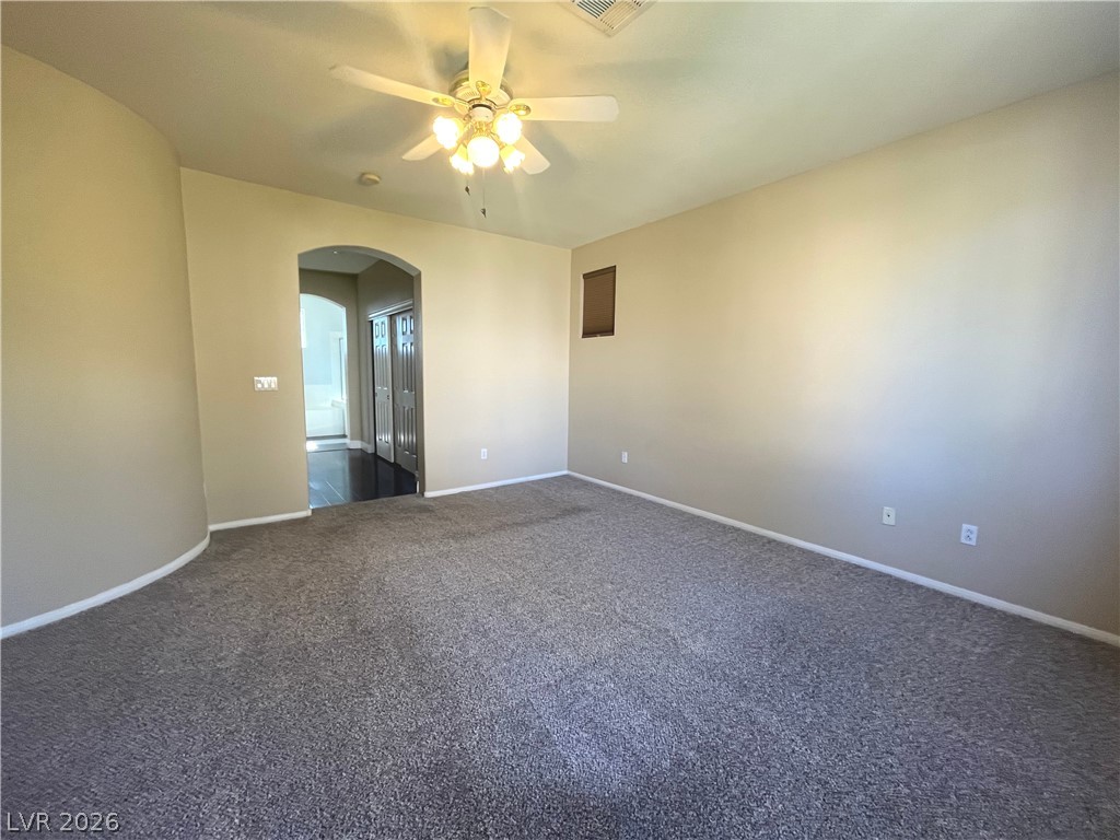 1809 Snow Spring Lane Las Vegas, NV 89134 - Photo 30 of 79 Primary bedroom w/ceiling fan & light, new carpet, two tone paint and walk in closet