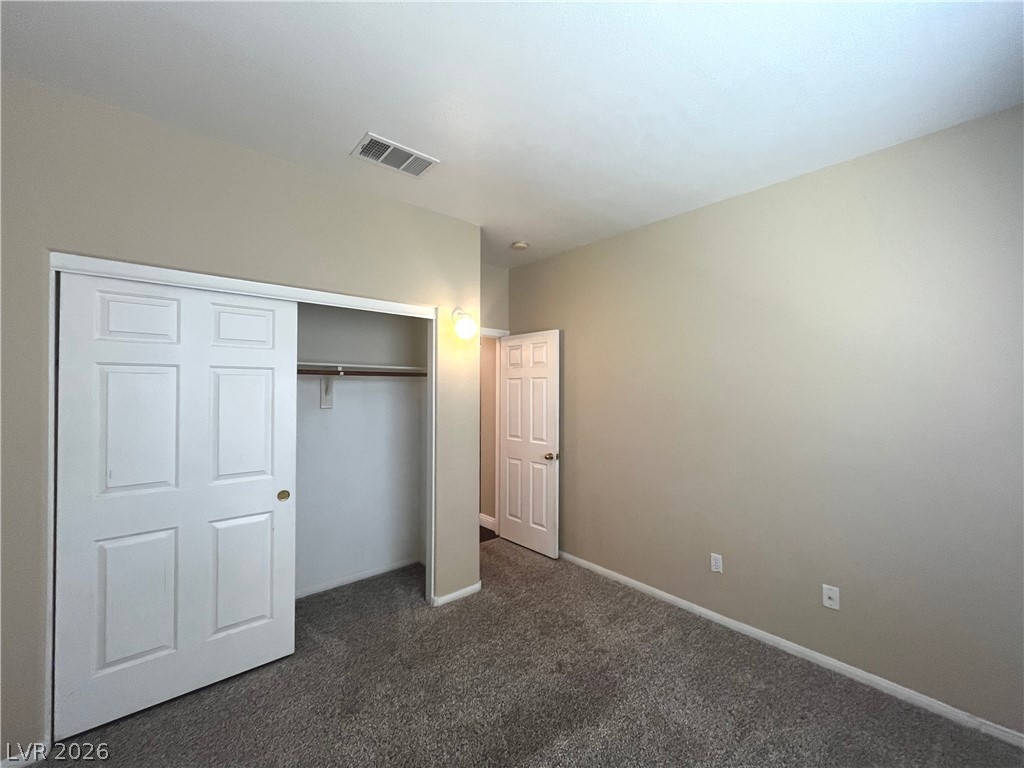 1809 Snow Spring Lane Las Vegas, NV 89134 - Photo 47 of 75 Bed 4 downstairs w/carpet, light and closet