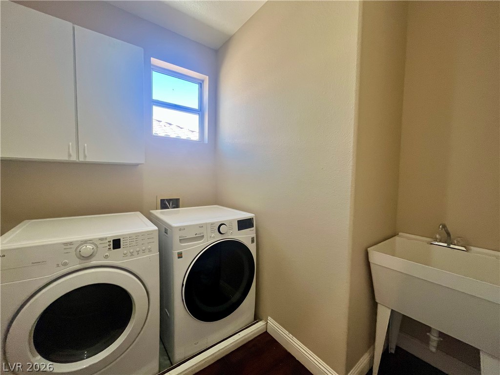 1809 Snow Spring Lane Las Vegas, NV 89134 - Photo 53 of 75 Laundry upstairs w/washer & dryer, sink and cabinets