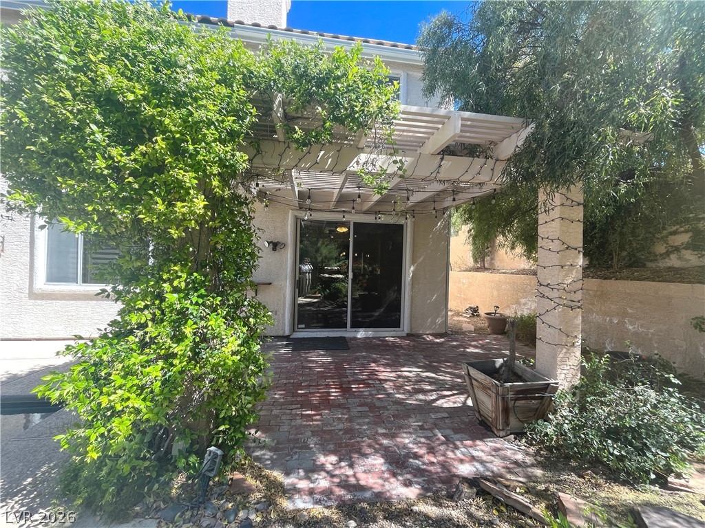 1809 Snow Spring Lane Las Vegas, NV 89134 - Photo 55 of 75 Step outside to the covered patio w/lush landscaping & indulge in the inviting pool or unwind in the soothing spa—a fantastic setting for relaxation and outdoor enjoyment.