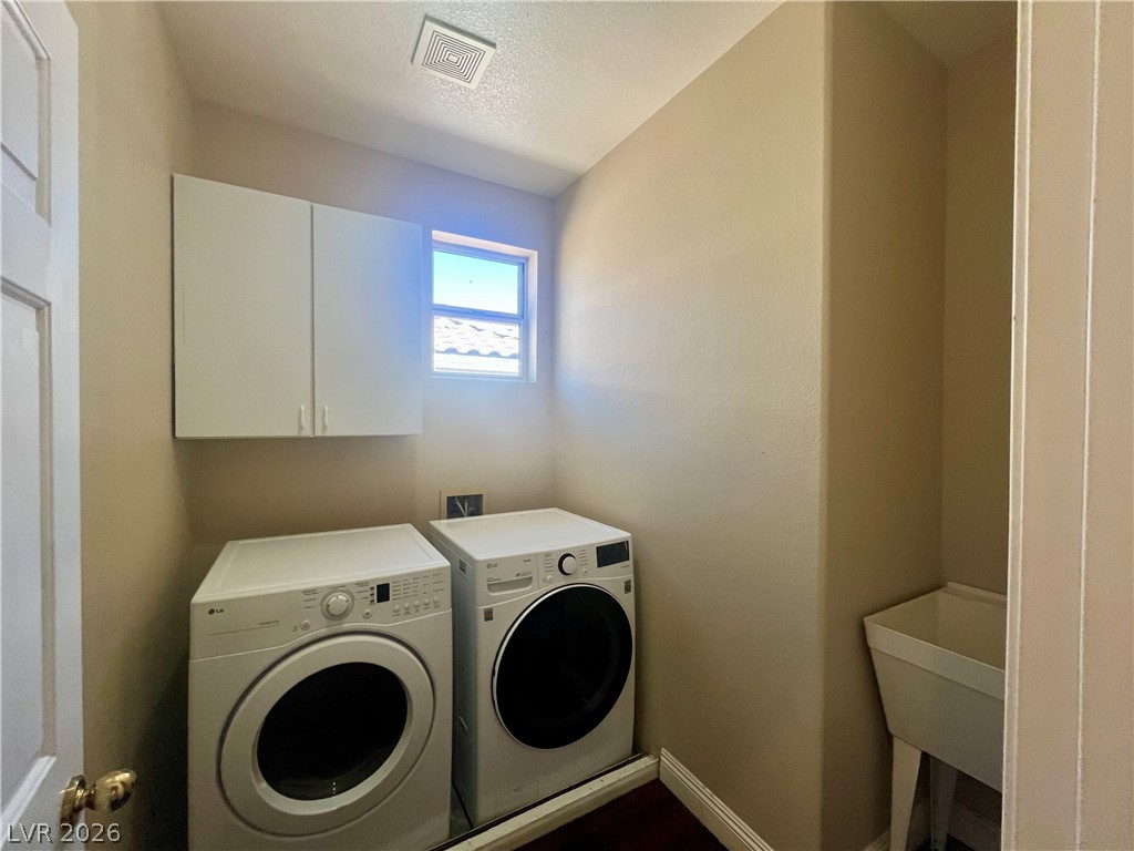 1809 Snow Spring Lane Las Vegas, NV 89134 - Photo 56 of 79 Laundry upstairs w/washer & dryer, sink and cabinets